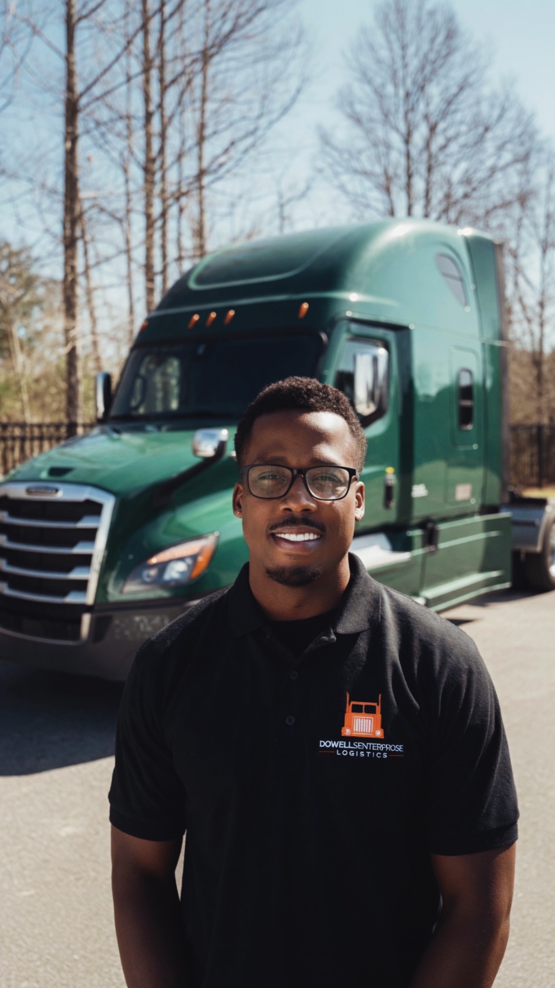 Founder standing in front of a green Freightliner Cascadia